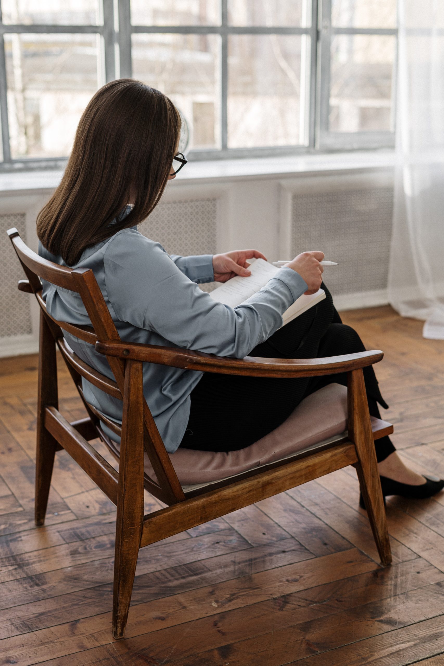 woman sitting in a chair reading